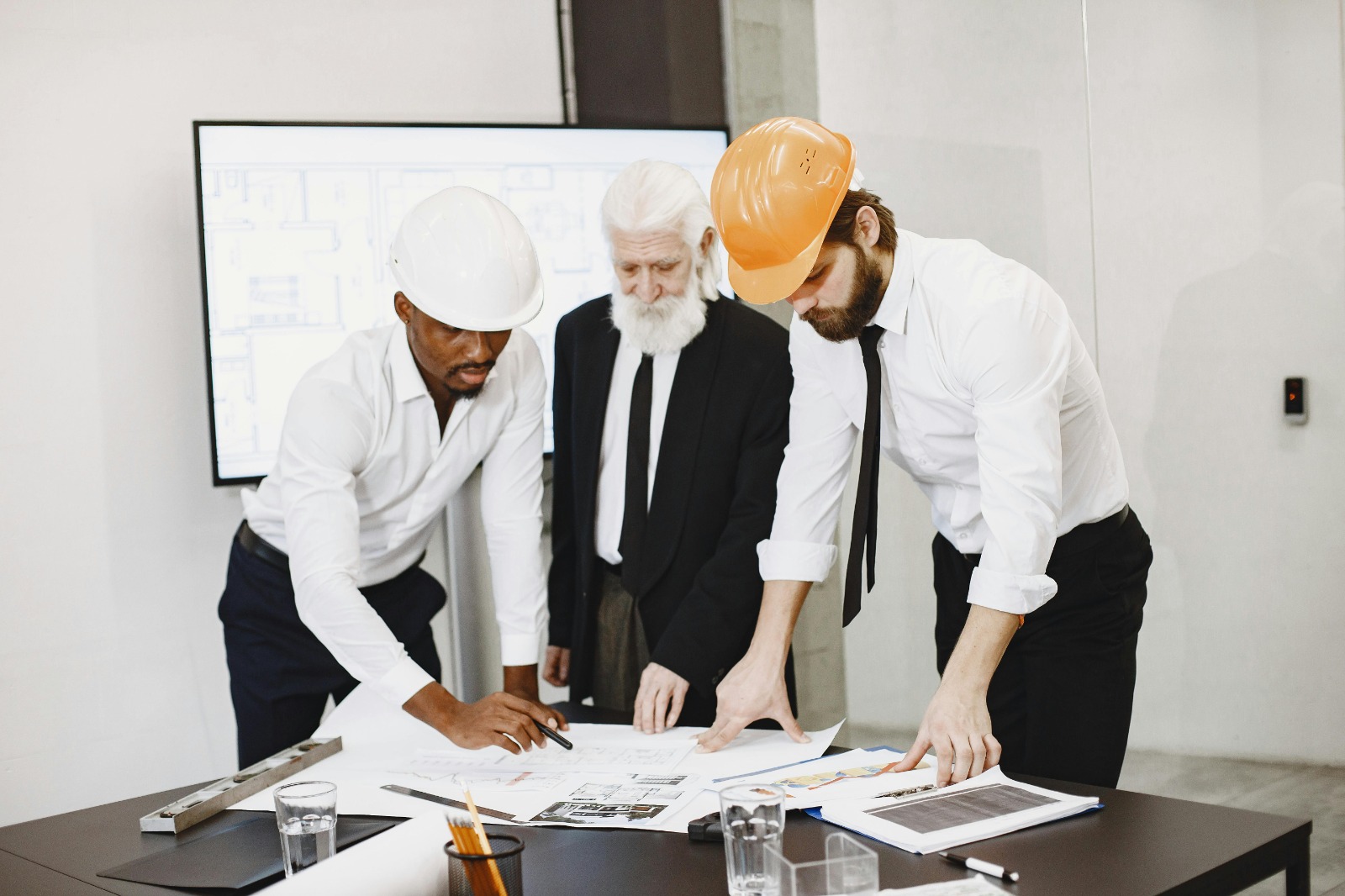 Architects and engineers collaborating on detailed structural design plans